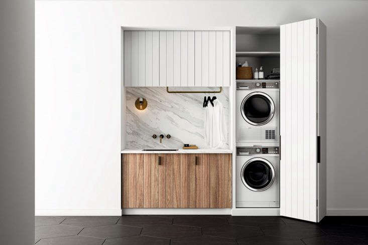  a stacked washer and dryer and storage shelves are concealed behind a paneled 15