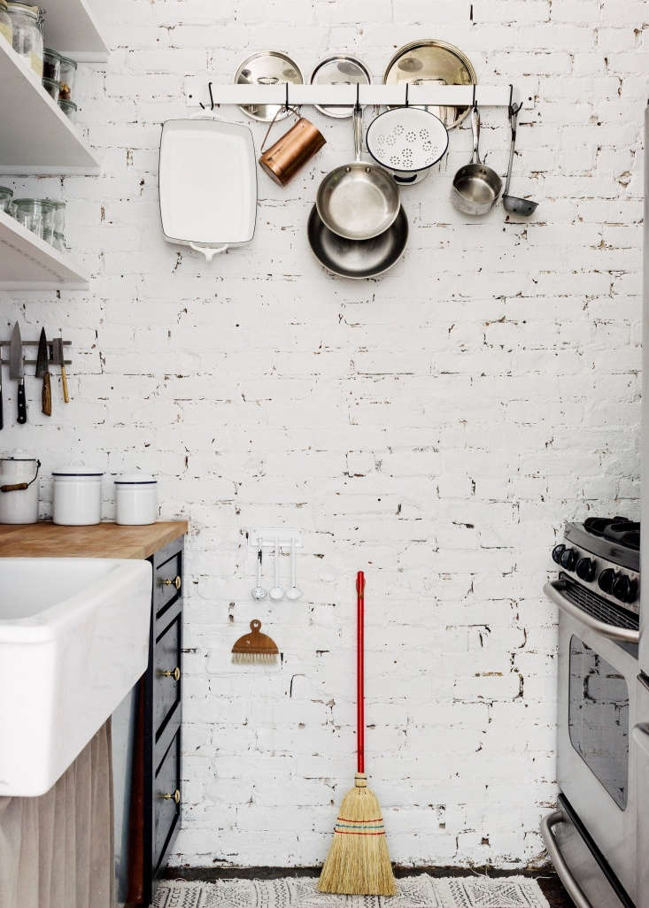in a tiny kitchen, a sink skirt creates another storage area to conceal cooking 21