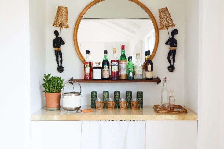 a white curtain panel blends seamlessly into this dining room bar. see vin 19