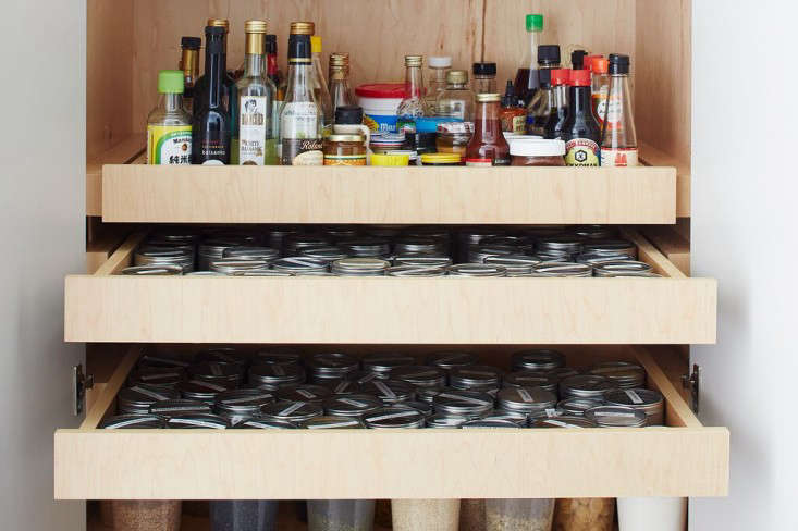 Vinegars on the left, cooking sauces on the right, and spice drawers underneath at Food52’s office kitchen. Photograph by Mark Weinberg, from Kitchen of the Week: The Ultimate Staff Kitchen in NYC.