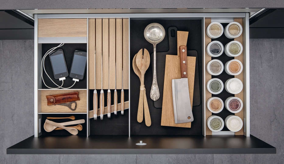 This highly organized kitchen drawer, courtesy of German company SieMatic, includes an area for charging small electronics. Photograph courtesy of SieMatic, from Kitchen of the Week: A Kitchen Modeled After a Sideboard.