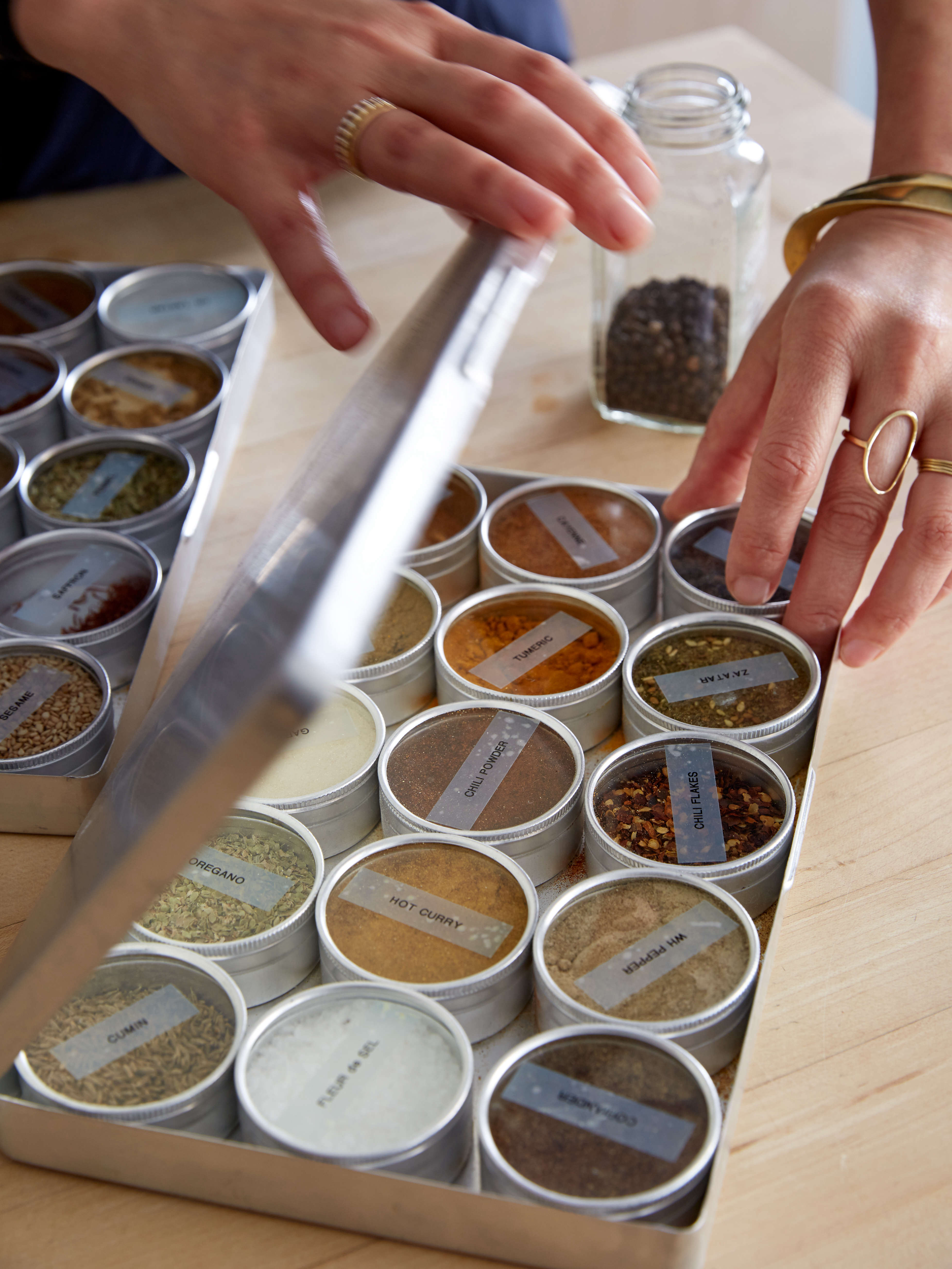 Spice storage idea for compact kitchens: tin boxes with glass tops