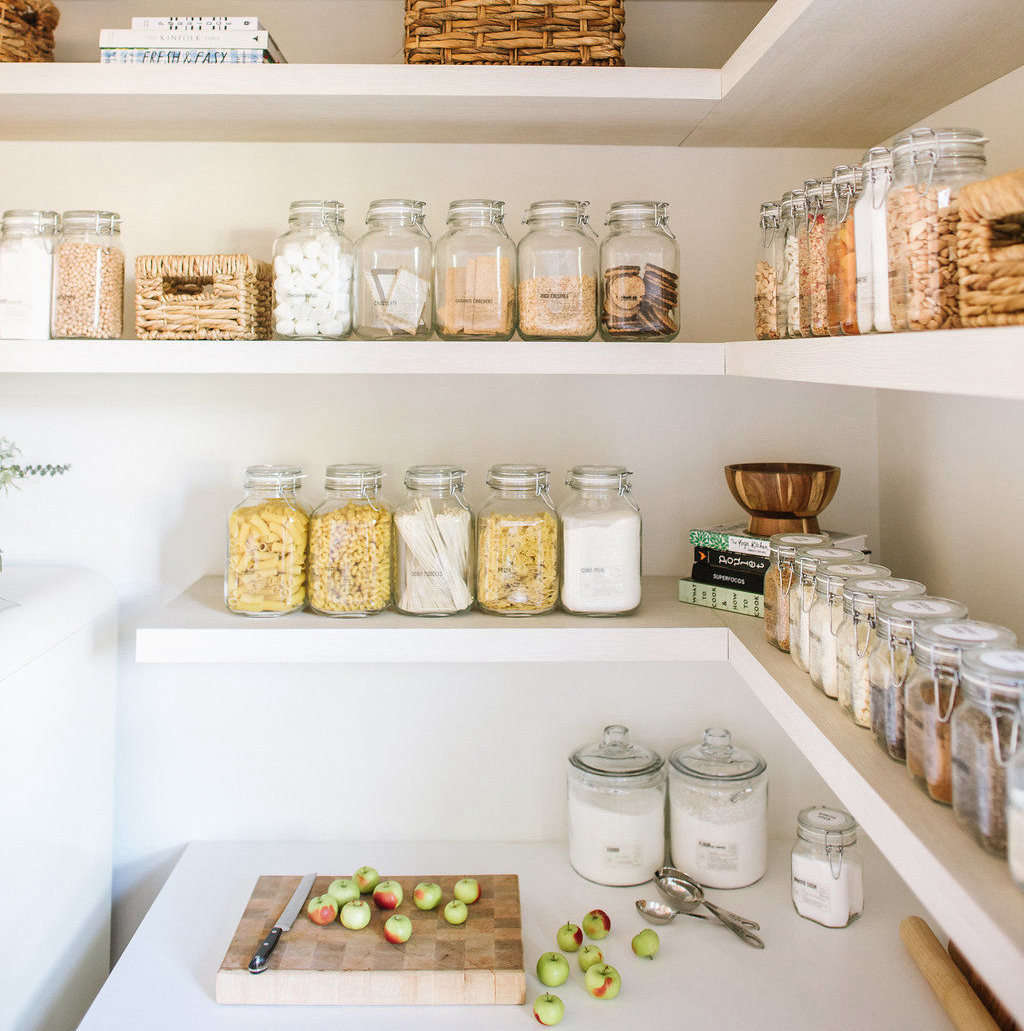 Flour and sugar are stored in wide-mouthed glass jars for easy scooping in this pantry. Photograph by Delbarr Moradi, from Steal This Look: The Modern Farmhouse Pantry (a Remodelista Considered Design Awards Finalist).