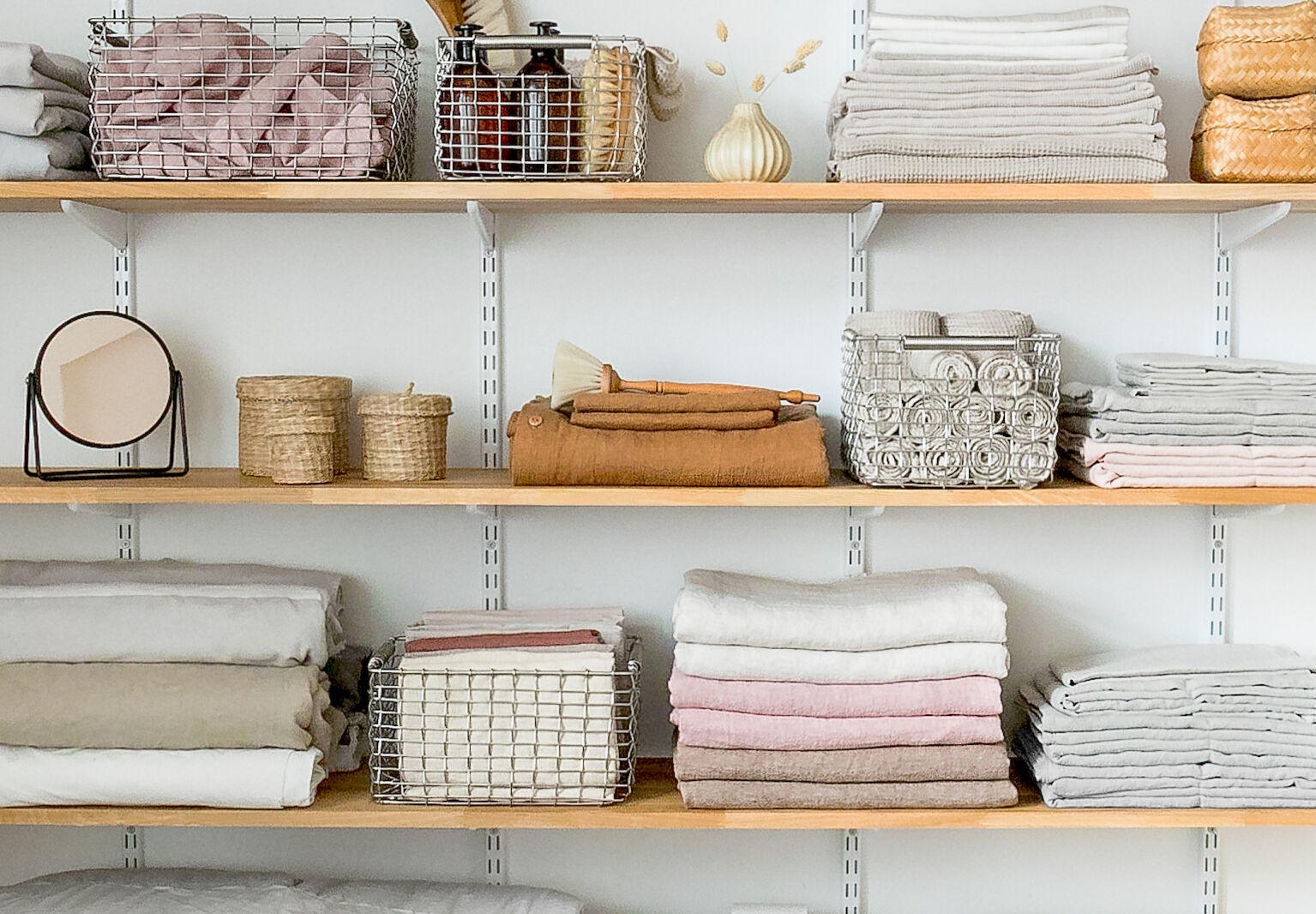 Linen closet goals: shelves with Korbo metal baskets.